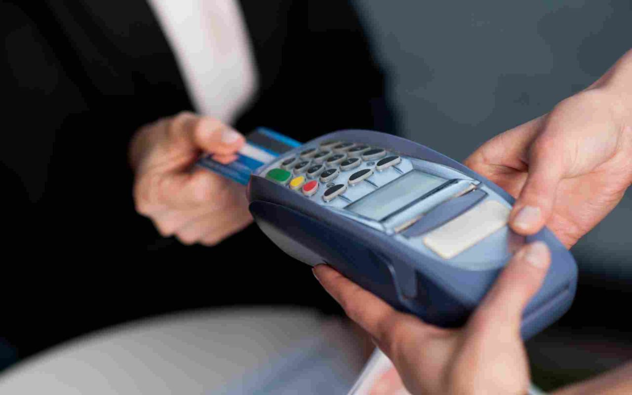 closeup of hands using a credit card reader